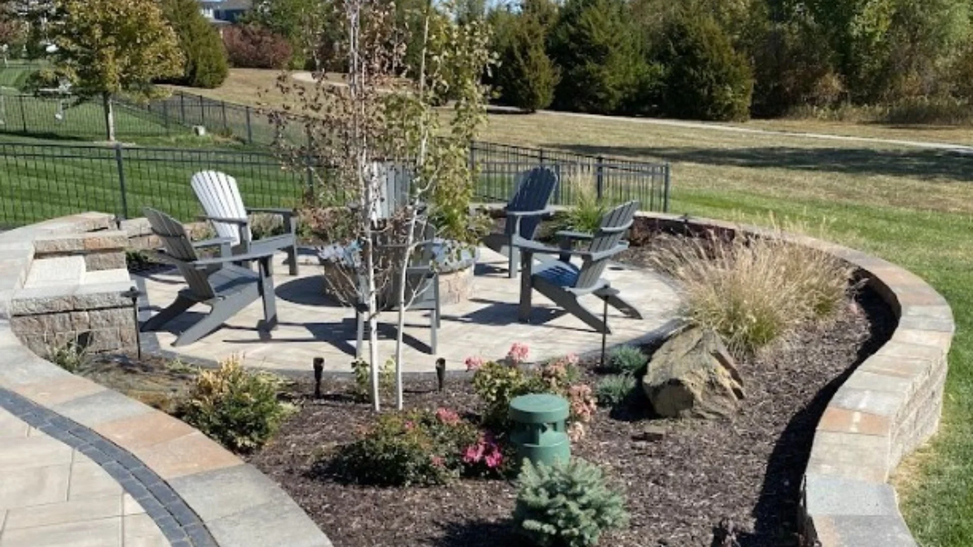 Yard with landscape beds and green grass in Olathe, KS.