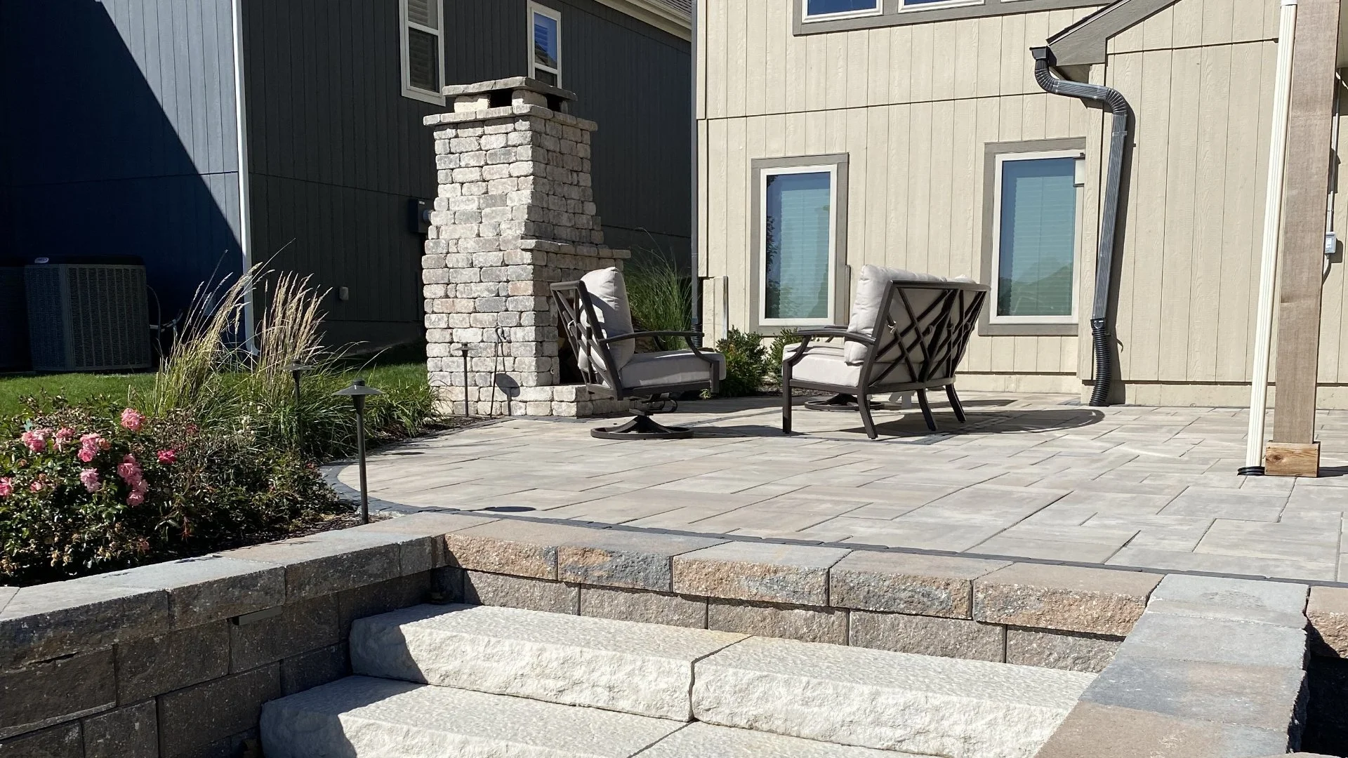 Landscape bed with mulch and trimmed plants.