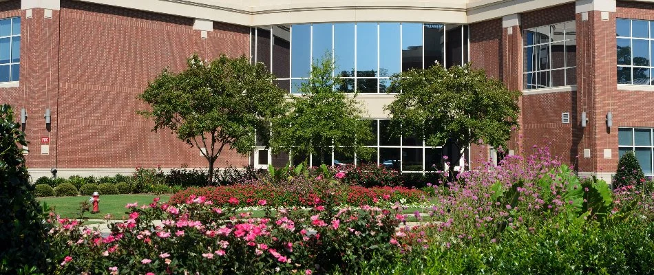 Flowers and trees in front of a building in Edgerton, KS.