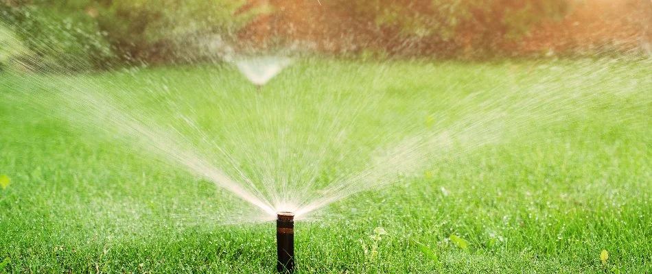 Lawn with running sprinklers in Overland Park, KS.