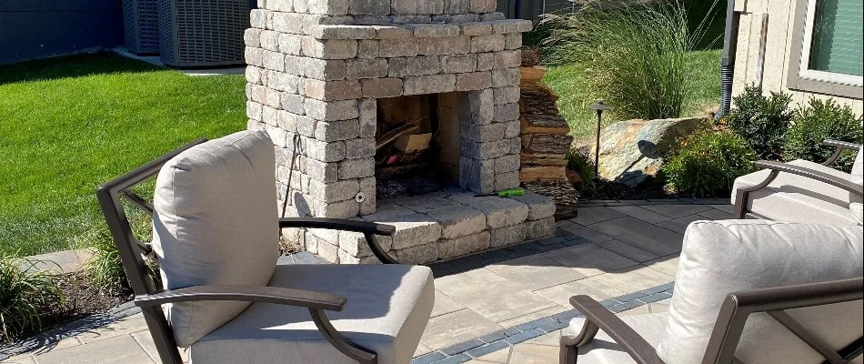 Patio in Loch Lloyd, KS, with chairs and an outdoor fireplace.