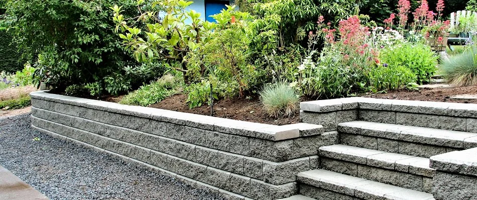 Retaining wall with plants and steps on a property in Olathe, KS.