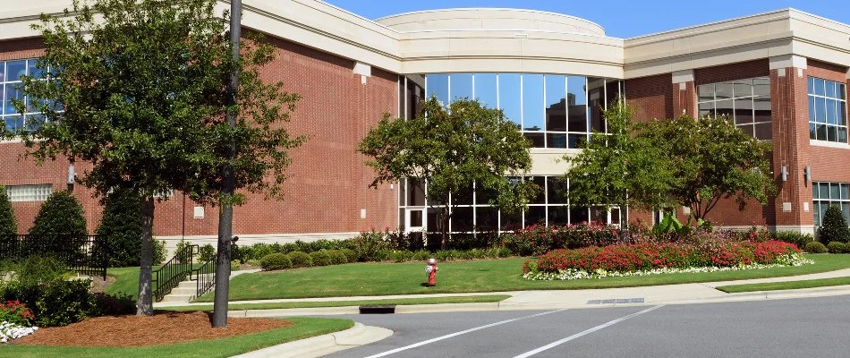 Trees, flowers, shrubs, and a lawn on a commercial property in Prairie Village, KS.