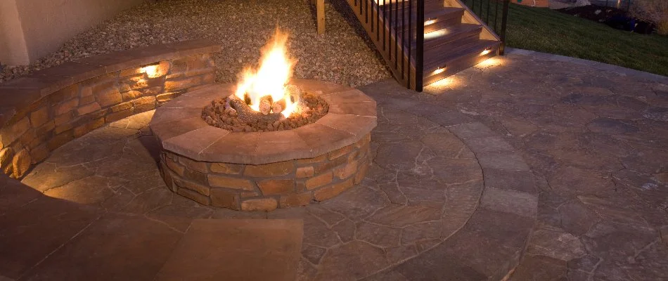 Wood-burning fire pit and seating wall in Olathe, KS.