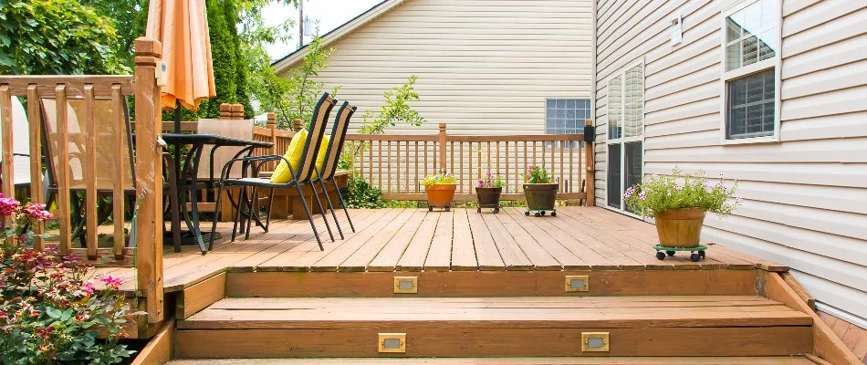 Wooden deck with steps and furniture in Olathe, KS.