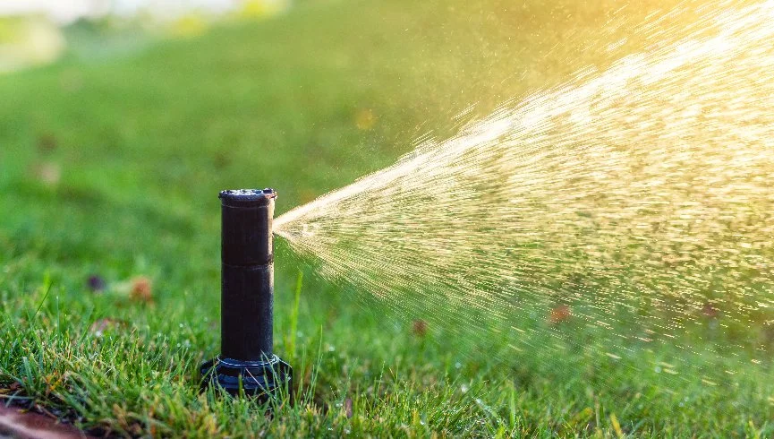 Outdoor living space with a fire pit and boulder retaining wall in Leawood, KS.